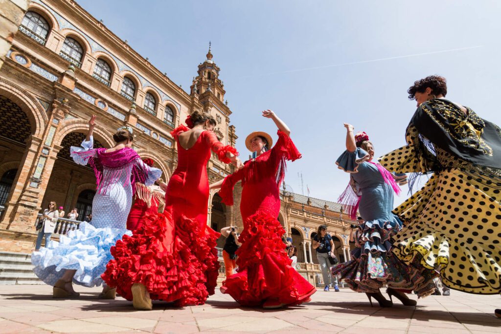 A group of people in red dresses dancing on the street.
