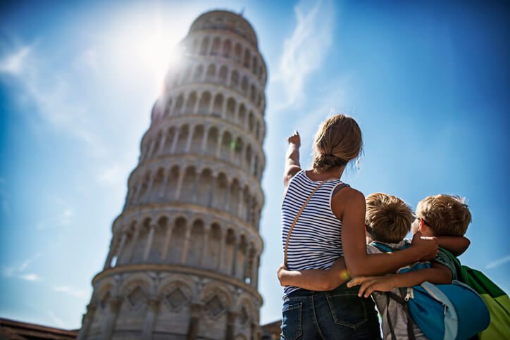 a woman showing a tower to the kids